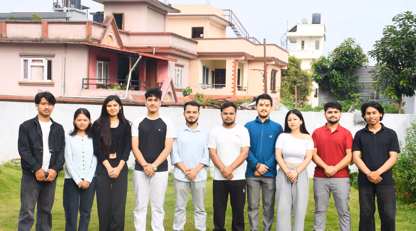 A line of twelve students on the lawn, the picture the college ran with its robotics championship post
