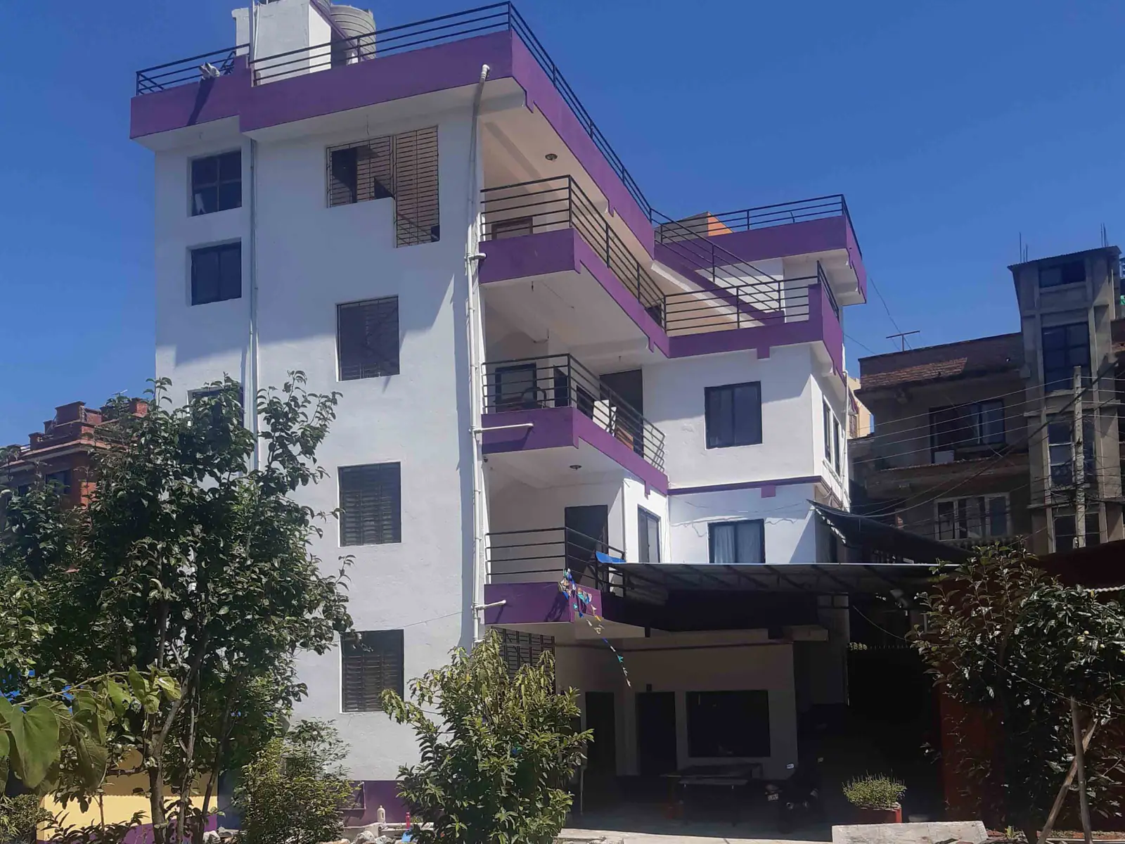 The institute's three-storey white and purple block behind its garden trees
